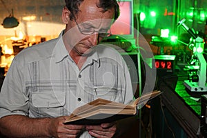 Scientist with glass read book in his lab