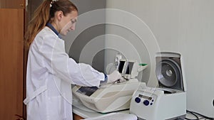Scientist with gloved hand putting DNA sample into real-time PCR-cycler