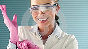 Scientist, goggles and face of woman with gloves for safety, science experiment and doctor for medical research. PPE