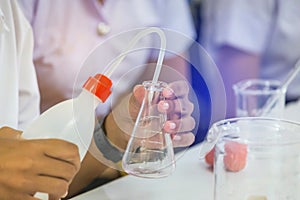 Scientist hand holding flask equipment for research experiments