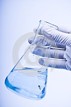 Scientist hand holding a flask in a research lab