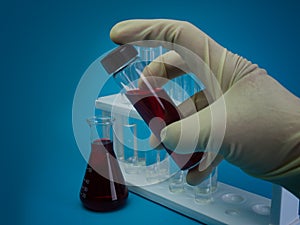Scientist hand holding laboratory test tube