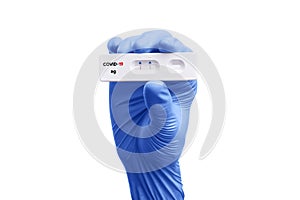 Scientist hand showing rapid test kit for viral disease COVID-19 2019-nCoV with positive result. Lab card kit test for viral sars-