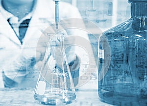 Scientist hand titration with burette and erlenmeyer flask, science laboratory research and development concept