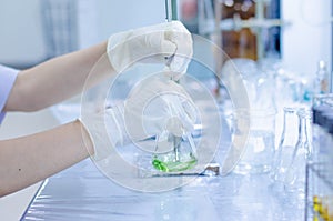 Scientist hand titration at laboratory