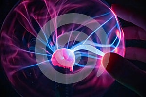 Scientist hand is touching a plasma ball