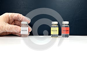 Scientist hands holding a vaccine vial for coronavirus covid-19 vaccine clinical trial and testing.