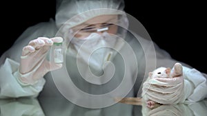 Scientist holding bottle with white powder and rat, illegal drug laboratory