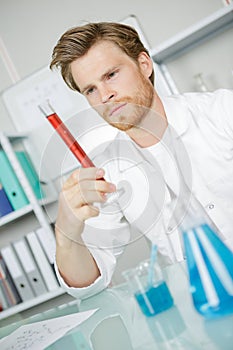 Scientist holding graduated cylinder