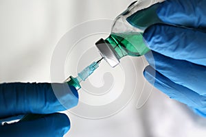 Scientist Holding Green Drug Vaccine Syringe