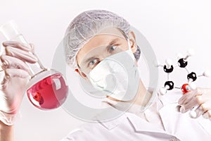 Scientist Holding Tube and Atoms