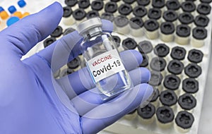 Scientist holds a coronavirus vaccine