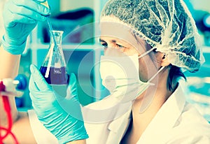 Scientist holds and examine samples