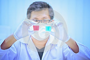 Scientist holds and examine samples in laboratory