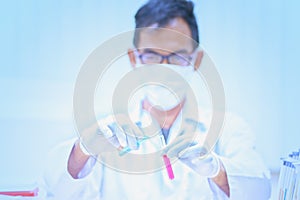 Scientist holds and examine samples in laboratory