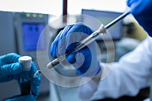 Scientist injecting a sample via the auto sampler photo