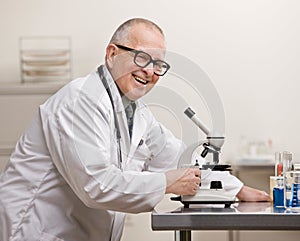 Scientist in lab coat with microscope