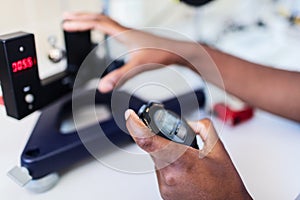 Scientist with laboratory clock and timer