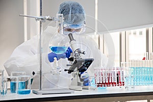 Scientist in laboratory with test tubes