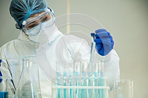 Scientist in laboratory with test tubes