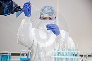 Scientist in laboratory with test tubes on Covid19