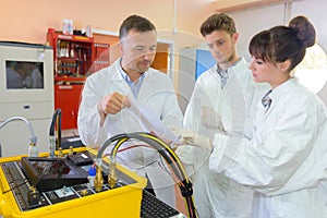 Scientist looking at readings from machine photo