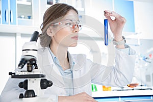 Scientist looking on test tube