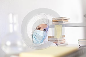 Scientist looking test tube with liquid reagent. Doctor and laboratory glassware