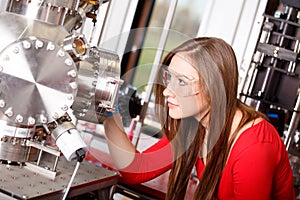 Scientist looking to the laser deposition chamber