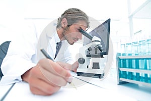 Scientist makes a note of experiment in the laboratory