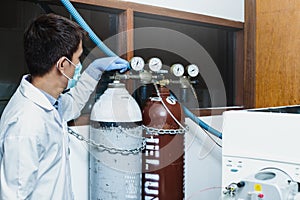 Scientist man control gas of instrumental Liquid Chromatography Mass Spectrometry LC MS