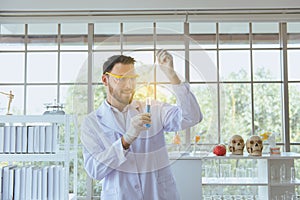 Scientist men working putting medical chemicals sample in test tube at laboratory