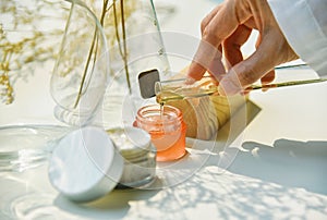 Scientist mixing natural skin care beauty products, Organic botany extraction and scientific laboratory glassware