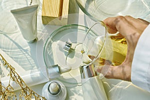 Scientist mixing natural skincare beauty products, Organic botany extraction and scientific laboratory glassware