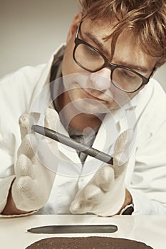 Archaeologist researcher taking samples of cuneiform material