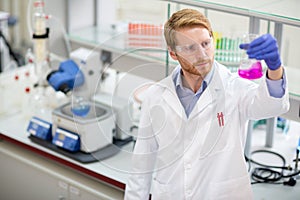 Scientist observing liquid reagent