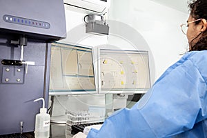 Scientist performing a flow cytometric analysis in the laboratory. Flow cytometer