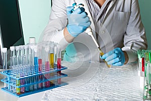 Scientist pipetting sample for study in tube