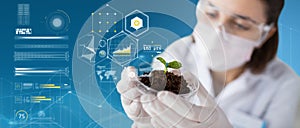 Scientist with plant and soil over virtual charts photo