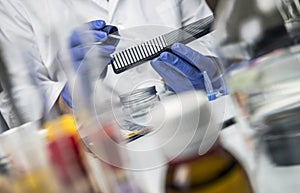 Scientist Police hold murder victim comb to find dna in crime lab
