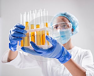 Scientist pouring organic oil. Beauty and cosmetics sciences.