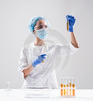 Scientist pouring organic oil. Beauty and cosmetics sciences.