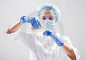 Scientist pouring organic oil. Beauty and cosmetics sciences.