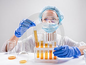Scientist pouring organic oil. Beauty and cosmetics sciences.