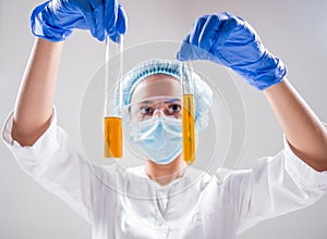 Scientist pouring organic oil. Beauty and cosmetics sciences.