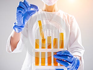 Scientist pouring organic oil. Beauty and cosmetics sciences.