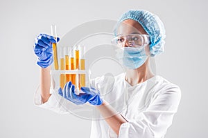 Scientist pouring organic oil. Beauty and cosmetics sciences.