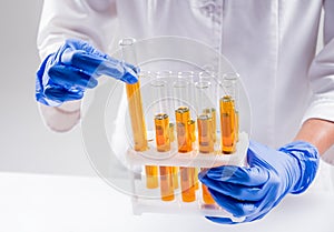 Scientist pouring organic oil. Beauty and cosmetics sciences.