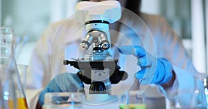 Scientist prepares sample for analysis using microscope
