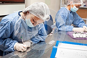 Scientist preparing paraffin blocks containing biopsy tissue for sectioning. Pathology laboratory. Cancer diagnosis photo